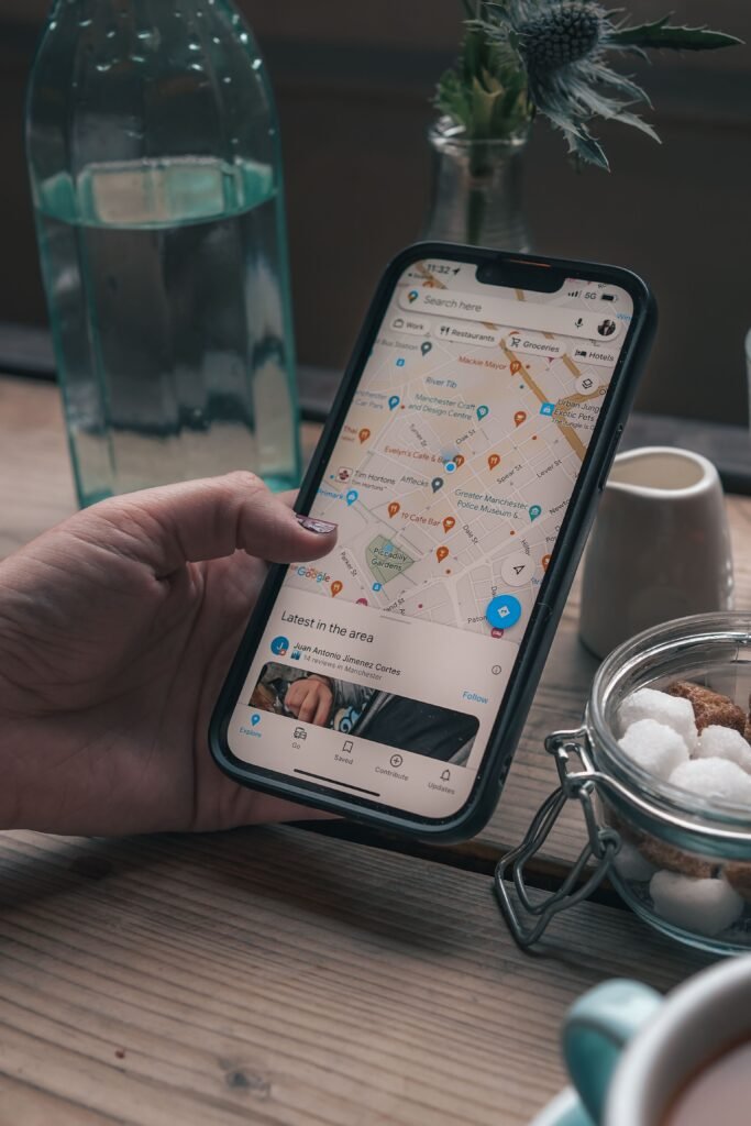 Google Maps listing of a local cafe on a phone showing photos, reviews and opening hours